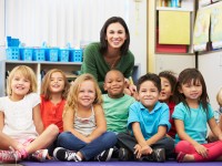 Group of Elementary Pupils In Classroom With Teacher