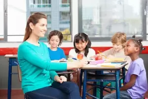 Teacher works with elementary students