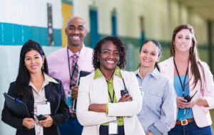 school staff smiling together