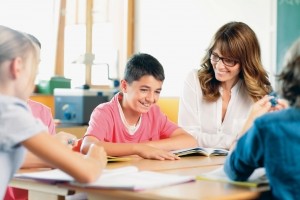 Frmale teacher works with middle-school students
