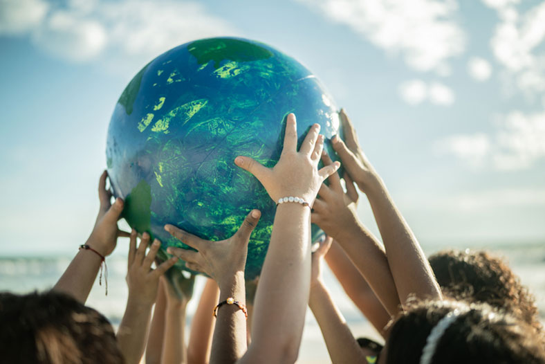 children holding up globe