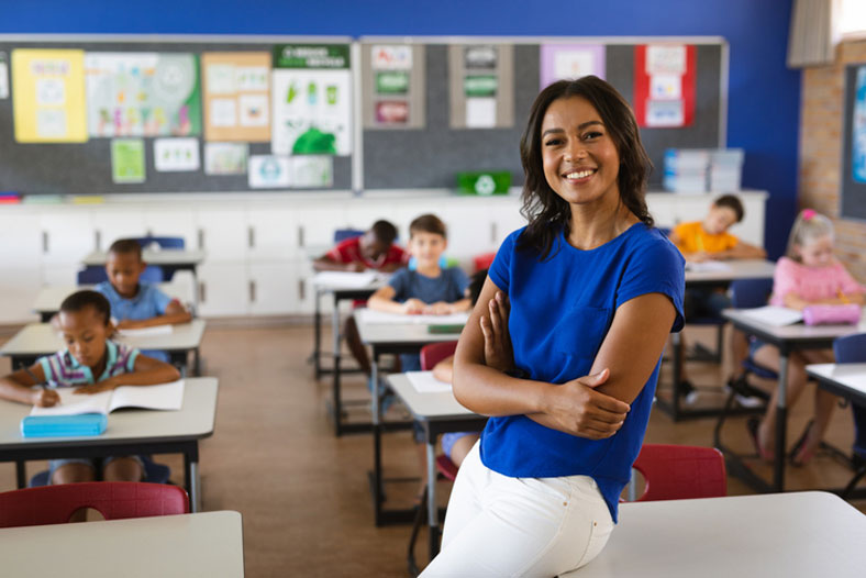 smiling elementary teacher in class