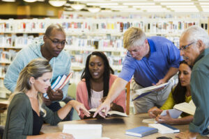 Teachers working together in school library 