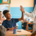 teacher high fiving student in classroom