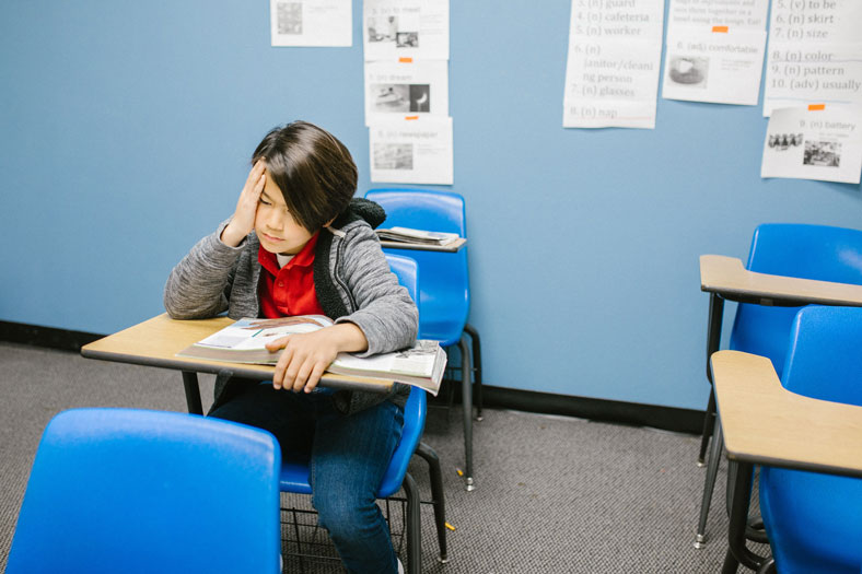 boy bored in classroom