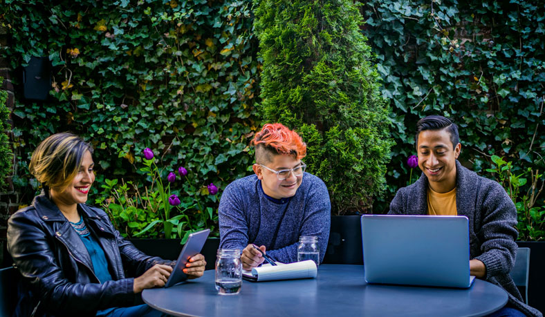 group on laptops outside